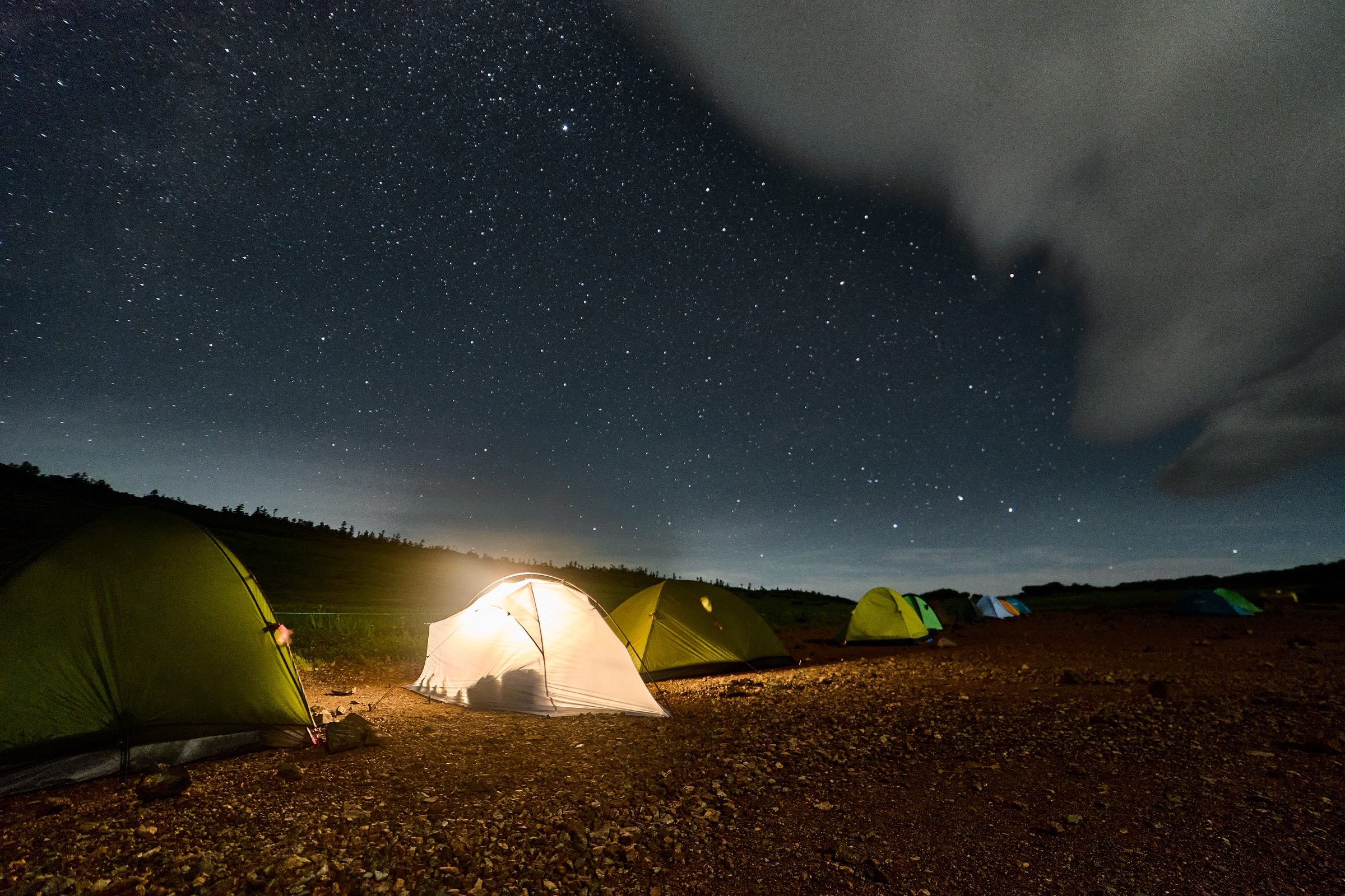 A mountain hut and surrounding ground photographed at night