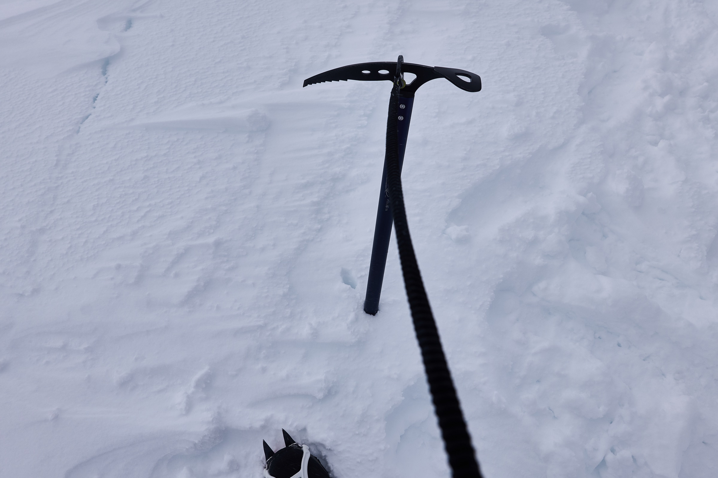 Ice axe planted in deep snow