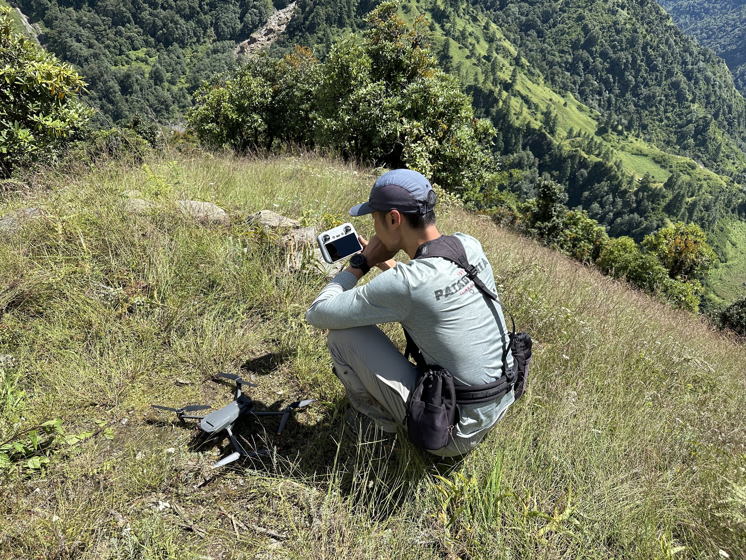 Jo Deok Rae reviewing aerial footage beside a drone in Gurja