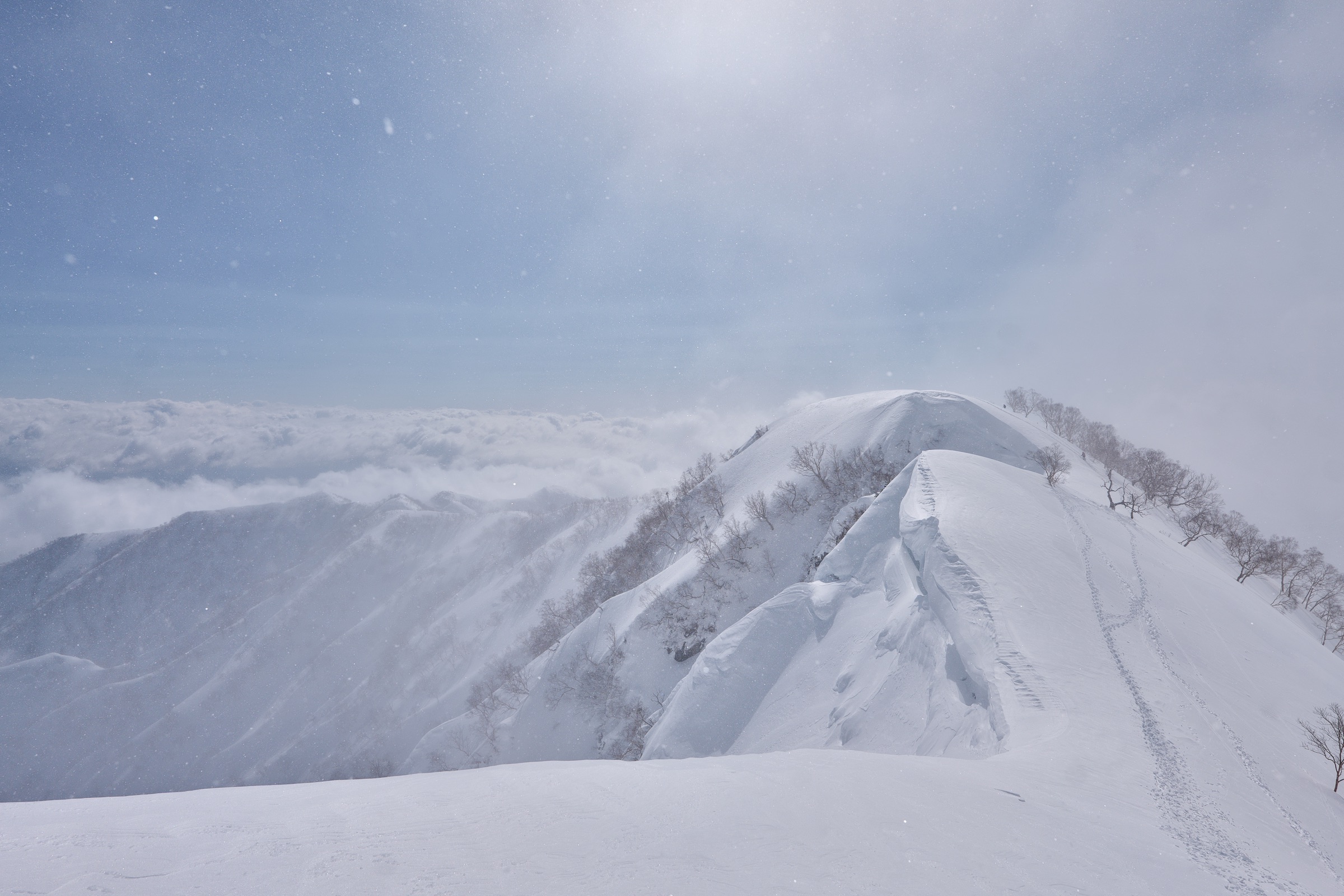 Snow-covered ridge during changing weather in Hakuba
